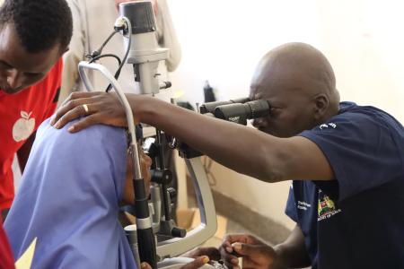 An ophthamologist screening a patient.
