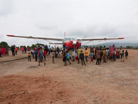 Kids excited about the MAF plane landing in Enairebuk - March 2023