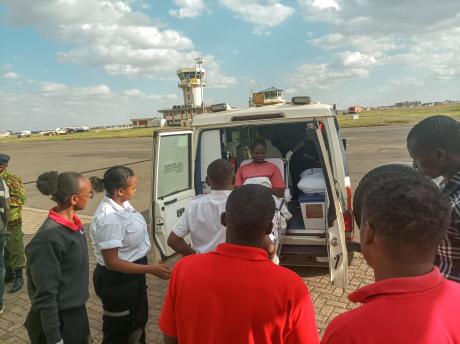 The medical team at Wilson Airport loading a patient into the ambulance for transfer.